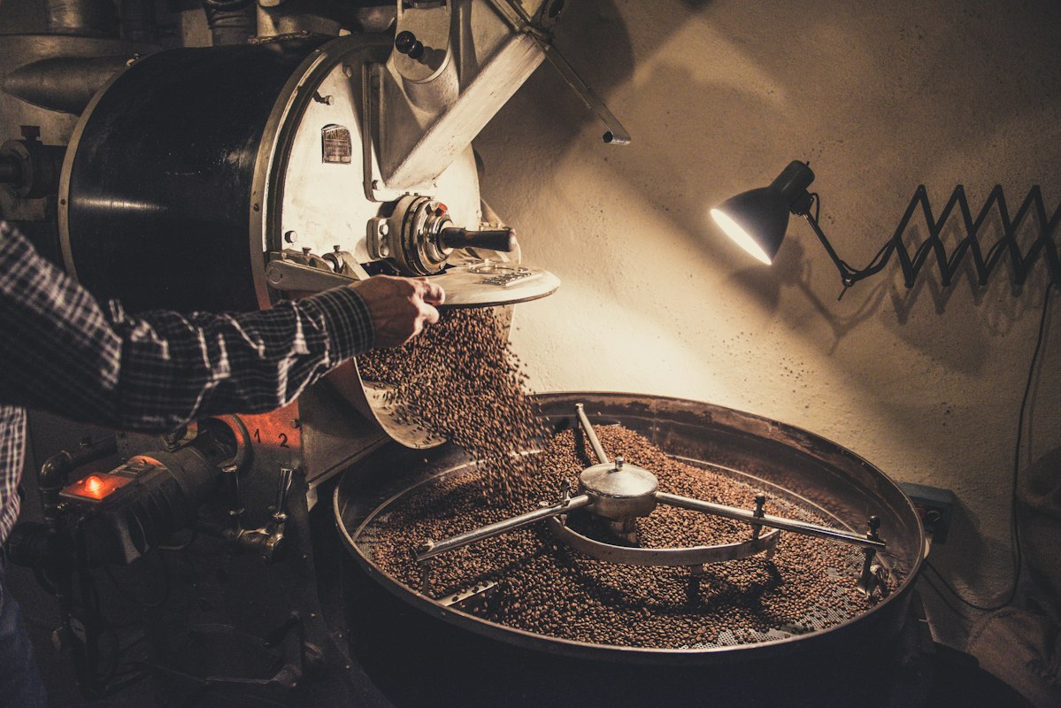 Premium coffee beans in wooden scoop